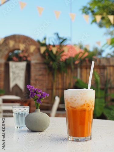 Coffee and Thai milk tea in backyard garden on sunny day