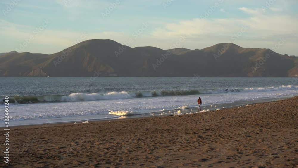 Girl Walks along Baker Beach in San Francisco California Girl Walks along Baker Beach in San Francisco California