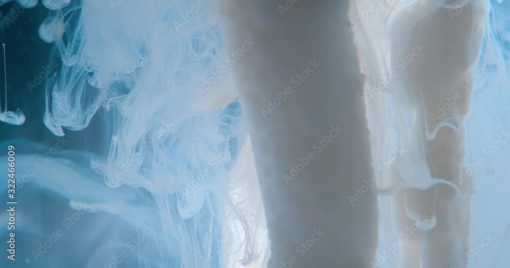 White Paint Threads and Drops Mixing in Water. Ink swirling. Underwater 4K Macro Shot. White Paint Threads and Drops Mixing in Water. Ink swirling. Underwater 4K Macro Shot.