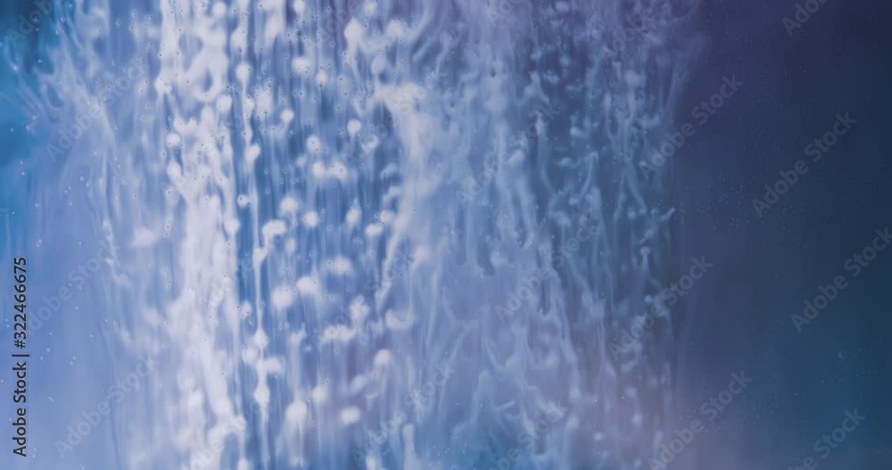 White Paint Threads and Drops Mixing in Water. Ink swirling. Underwater 4K Macro Shot. White Paint Threads and Drops Mixing in Water. Ink swirling. Underwater 4K Macro Shot.