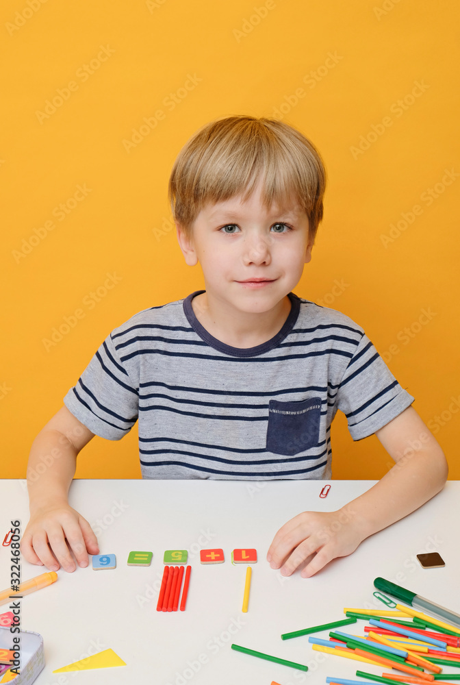 Back to school. Little boy preparing for elementary school doing simple Mathematics exercises Back to school. Little boy preparing for elementary school doing simple Mathematics exercises