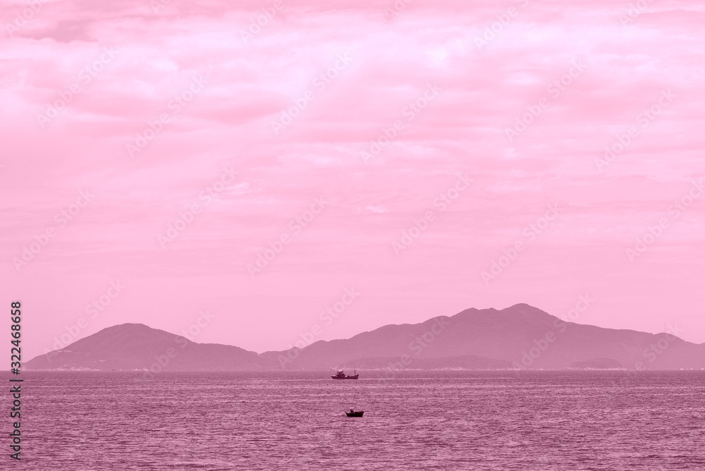 Morning seascape with islands and boats. Hoi An, Vietnam. Pink color toned