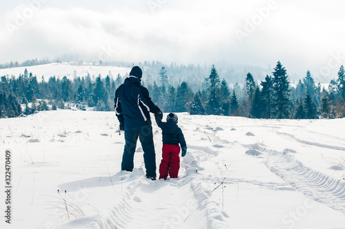 Father and son enjoing great view of winter landscape