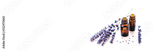 Dried lavender with a bottle of essential oil isolated on white background.