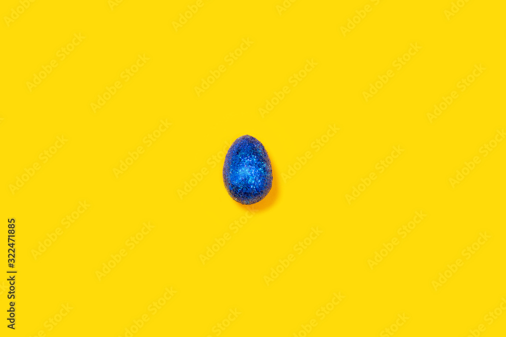 Blue easter egg on a yellow background.