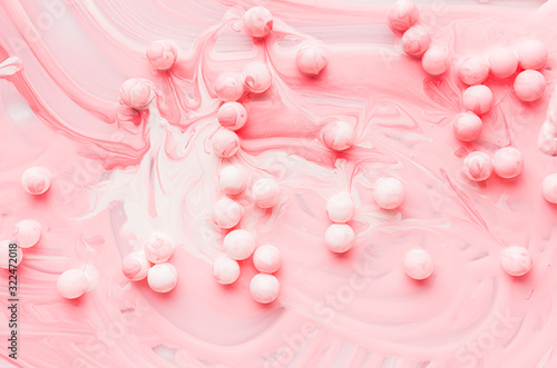 Drops  splashes and stain liquid pink paint with round balls  painted abstract background  texture.
