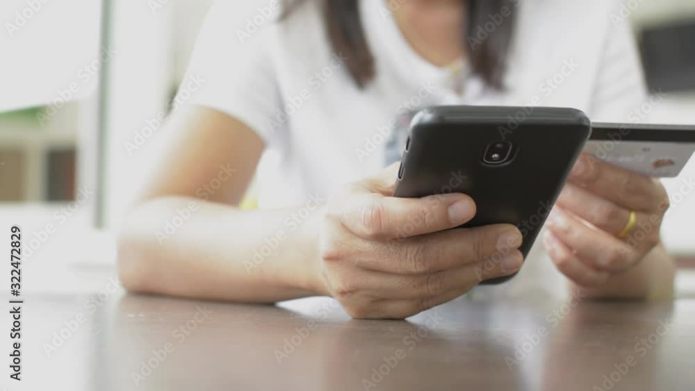 Woman shopping online at home with credit card, Online banking with smart phone, Easy pay using smart phone or digital device. Woman shopping online at home with credit card, Online banking with smart phone, Easy pay using smart phone or digital device.