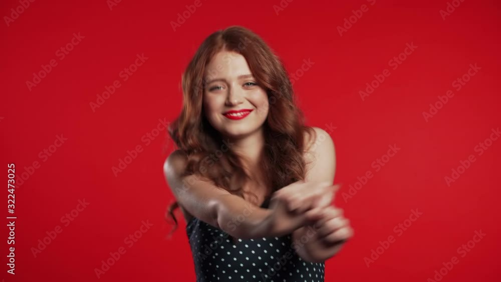 Beautiful woman with beautiful hair funny dancing on red studio background. Cute girls portrait. Party, happiness, freedom, youth concept. Beautiful woman with beautiful hair funny dancing on red studio background. Cute girls portrait. Party, happiness, freedom, youth concept.