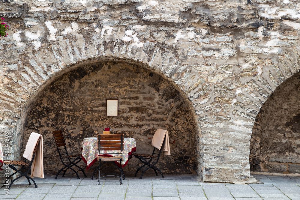 Old town street restaurant Empty table and chairs in Tallinn, Estonia