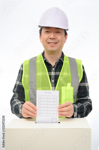 Man's hand down the ballot in the ballot box. photo