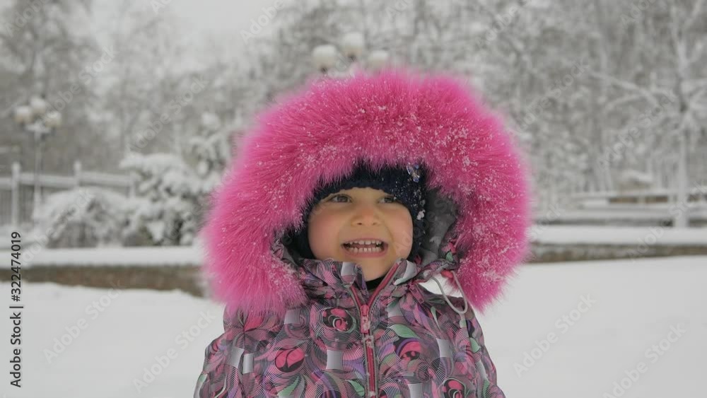 Closeup portrait of cute adorable baby girl outdoor in snowy frosty winter park Closeup portrait of cute adorable baby girl outdoor in snowy frosty winter park