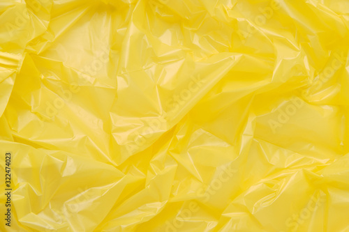 Close up Texture of a Yellow Plastic garbage Bag. Yellow Polyeth
