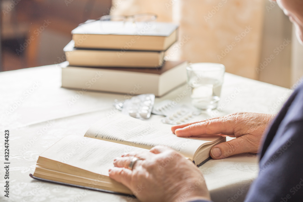 Elderly Caucasian Woman Reads A book. Pensioner Relaxation and brain education pleasure concept. Close Up.