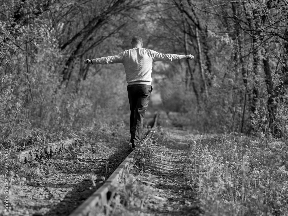Fototapeta premium A man goes on rails..