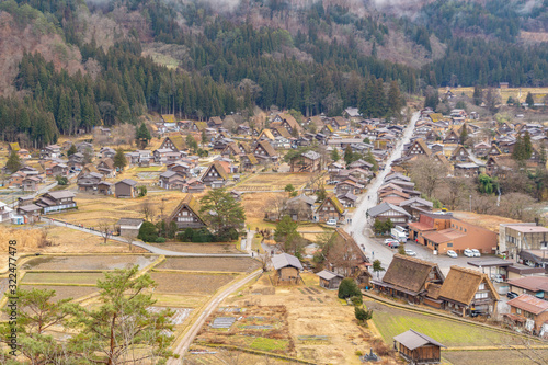 Traditional cottage houses in Shirakawago village with mountain hills in travel trip and holidays vacation in sunmer season, Gifu, Japan. Architecture landscape background. World heritage photo