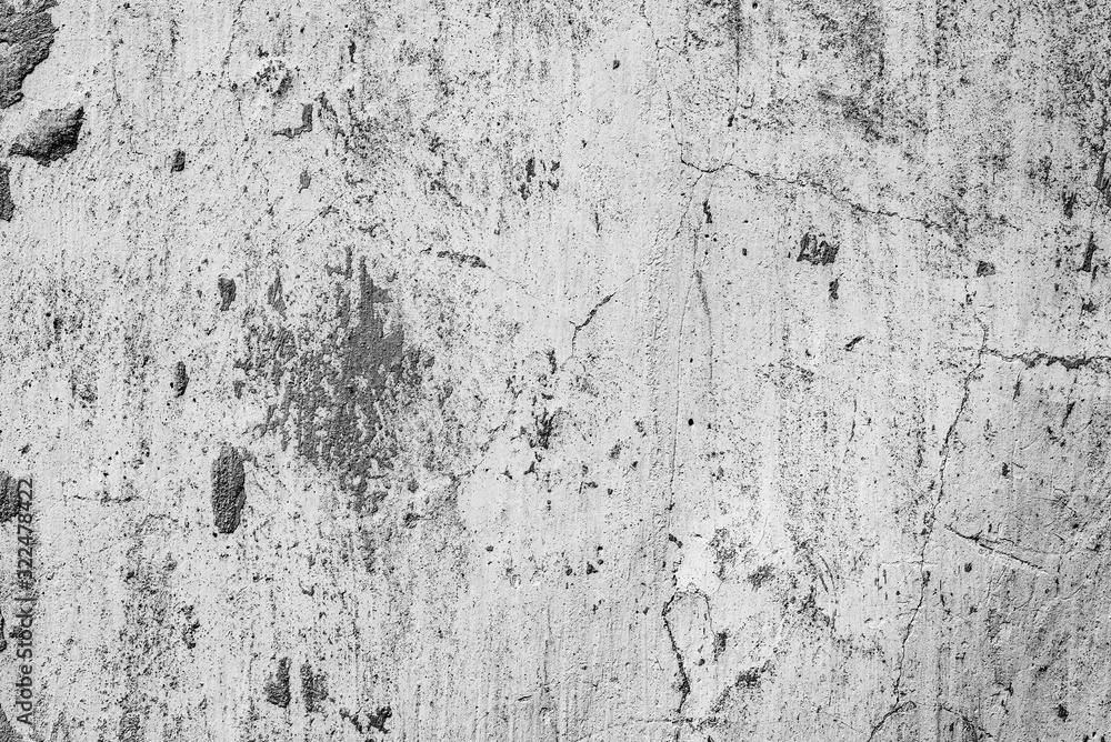 Fototapeta premium Texture of a concrete wall with cracks and scratches which can be used as a background