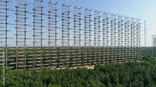 Aerial view of the DUGA radar station near the city of Chernobyl-2 among the forest. Exclusion Zone. Camera moves back. 4K drone footage. photo