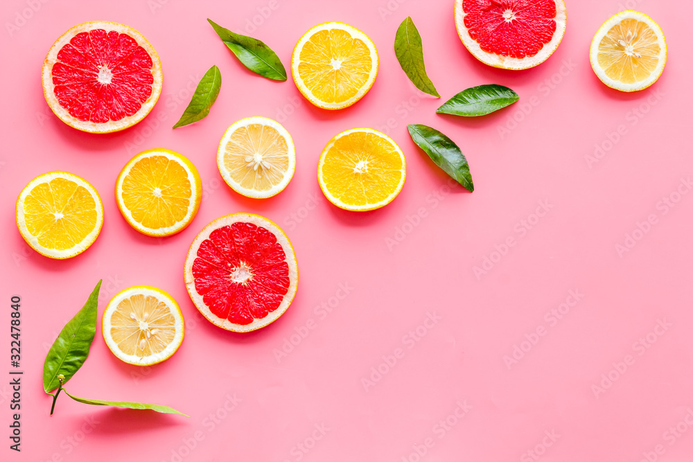 Citrus slices frame - lemons, grapefruits, leaves - on pink background top-down copy space Citrus slices frame - lemons, grapefruits, leaves - on pink background top-down copy space