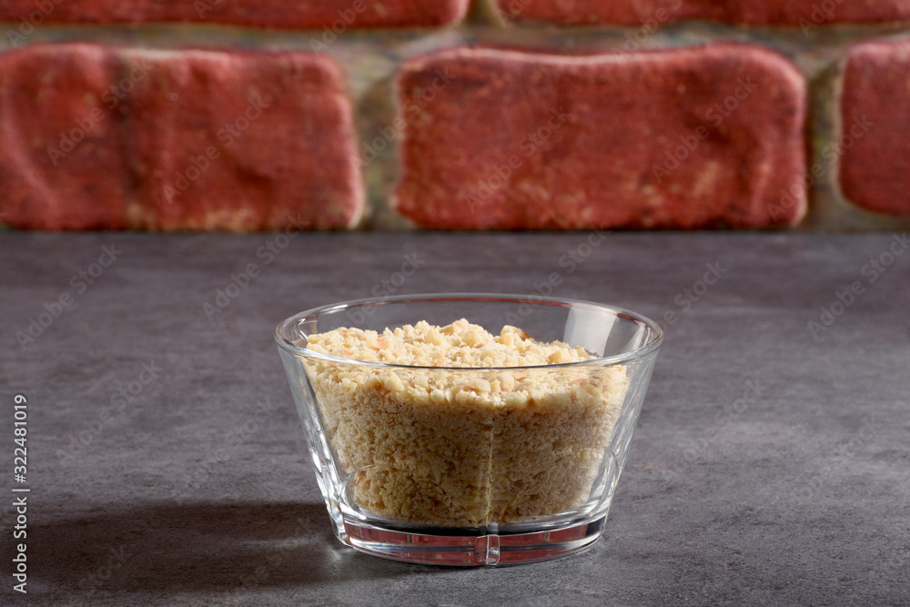 Crushed hazelnut pieces in a glass bowl Crushed hazelnut pieces in a glass bowl