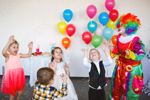 Children play with a clown