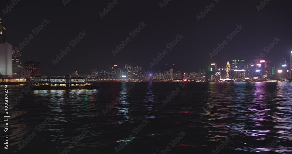 Shot from the Star Ferry towards the Central Ferry Pier on Hong Kong Island. Victoria Harbour by night, Hong Kong, China. Beautiful high dynamic range professional footage. Shot from the Star Ferry towards the Central Ferry Pier on Hong Kong Island. Victoria Harbour by night, Hong Kong, China. Beautiful high dynamic range professional footage.