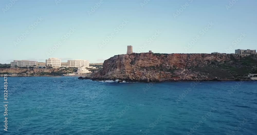 Aerial ascent towards defense tower on a sea cliff