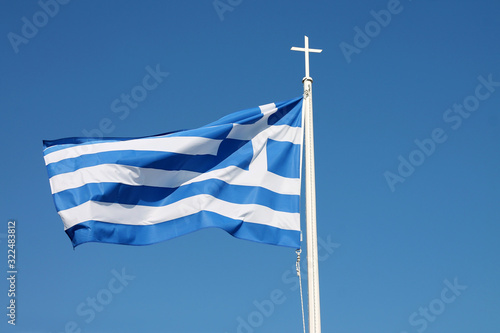 Waving flag of Greece on the blue sky.