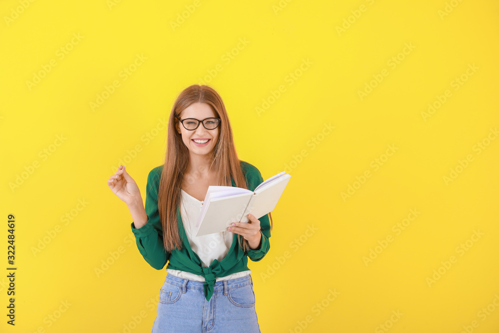 Beautiful young woman with book on color background Beautiful young woman with book on color background