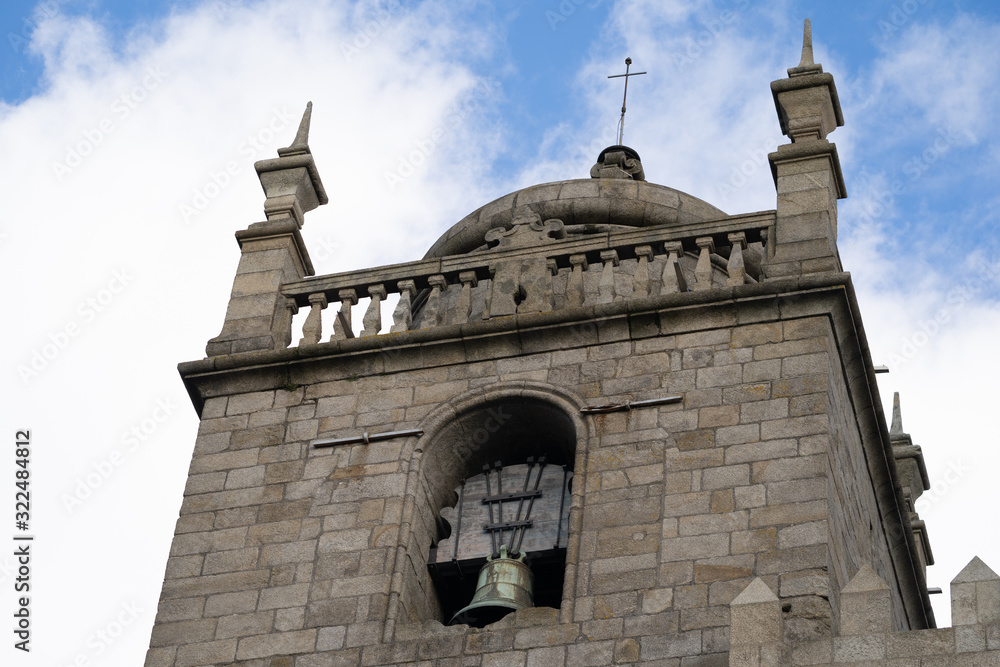 Φωτογραφία The Porto Cathedral bell tower close up, detail view against a blue sky with clo