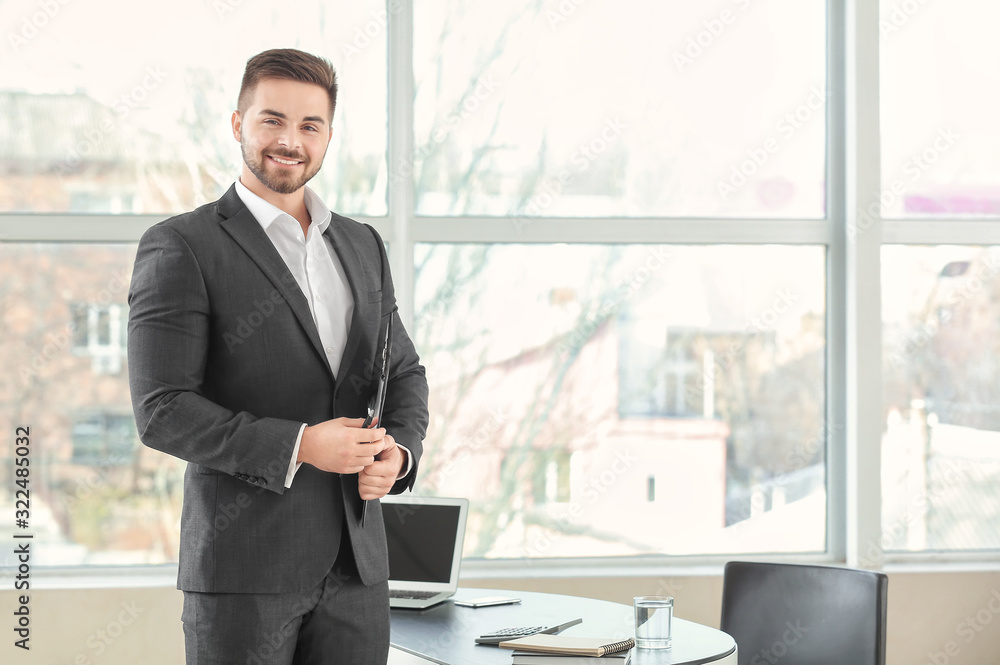 Portrait of young bank manager in office