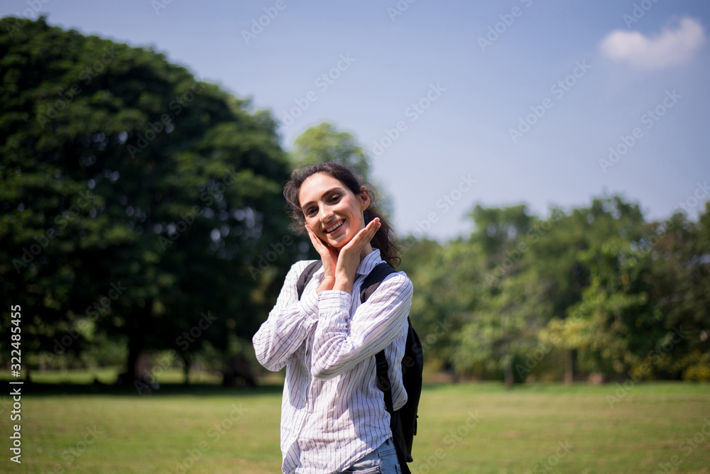 Beautiful young woman walking at public park in the morning,Happy and smiling,Relax time Beautiful young woman walking at public park in the morning,Happy and smiling,Relax time