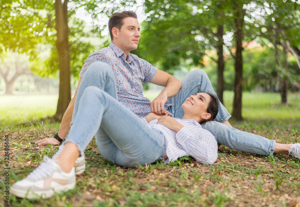 Couple young lover lying down on green grass in park together,Romantic and enjoying in moment of happiness time,Happy and smiling,Positive thinking,Eyes contact Couple young lover lying down on green grass in park together,Romantic and enjoying in moment of happiness time,Happy and smiling,Positive thinking,Eyes contact