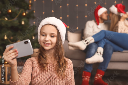 Little girl taking selfie o...