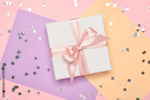 Beautiful gift box on color background © Pixel-Shot
