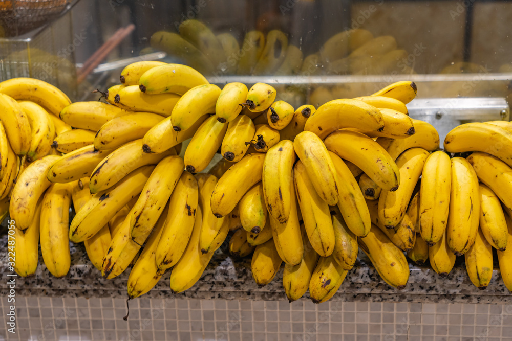 Bunches of yellow ripe banana at food stand