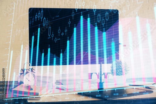 Forex market graph hologram and personal computer on background. Double exposure. Concept of investment. © peshkova