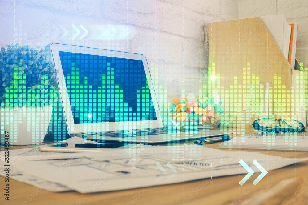 Financial graph colorful drawing and table with computer on background. Double exposure. Concept of international markets. Financial graph colorful drawing and table with computer on background. Double exposure. Concept of international markets.