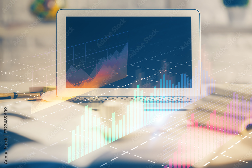 Stock market chart hologram drawn on personal computer background. Multi exposure. Concept of investment. Stock market chart hologram drawn on personal computer background. Multi exposure. Concept of investment.