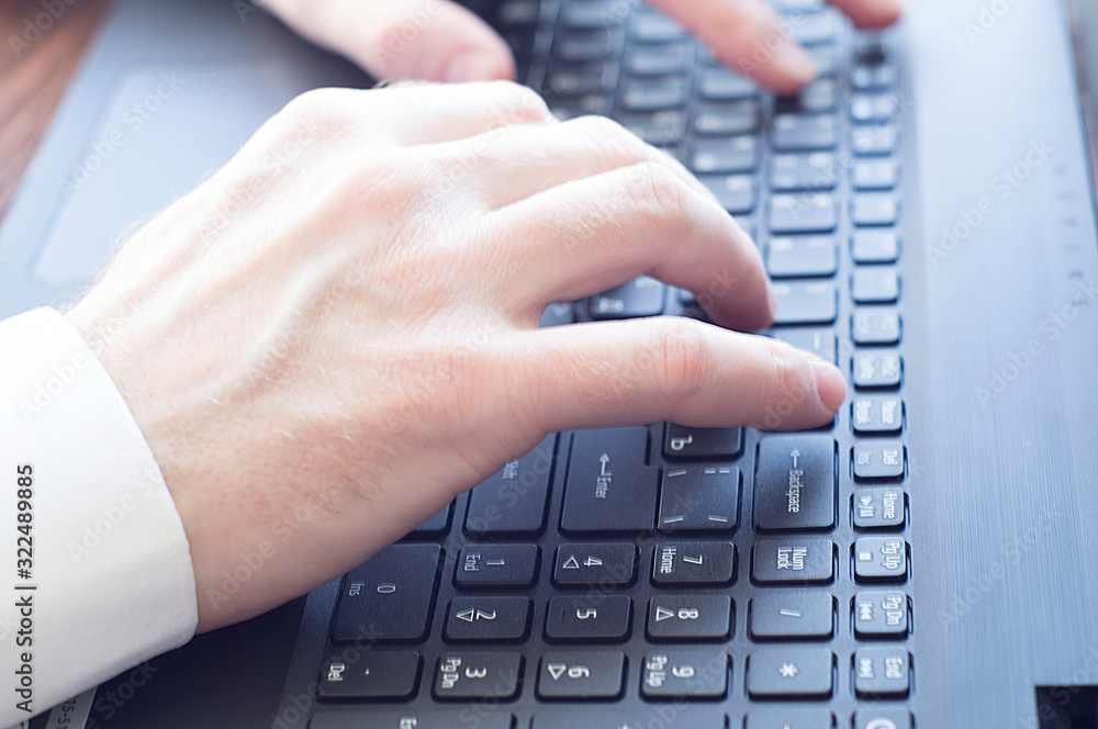 Closeup of businessman typing on laptop computer Closeup of businessman typing on laptop computer