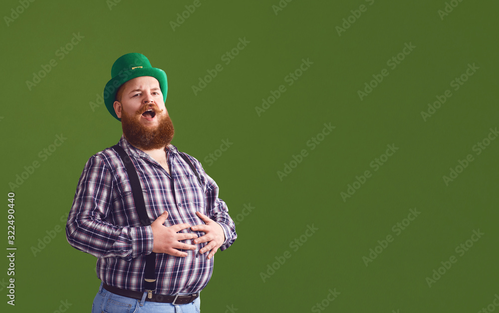 Happy Patrick's Day. Funny fat bearded man in a green hat is laughing on a green background. Happy Patrick's Day. Funny fat bearded man in a green hat is laughing on a green background.