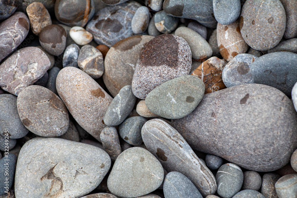 sea pebbles colored granite on the beach background stones. sea pebbles colored granite on the beach background stones.