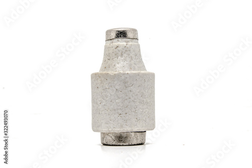 Old ceramic electric fuse on white background.
