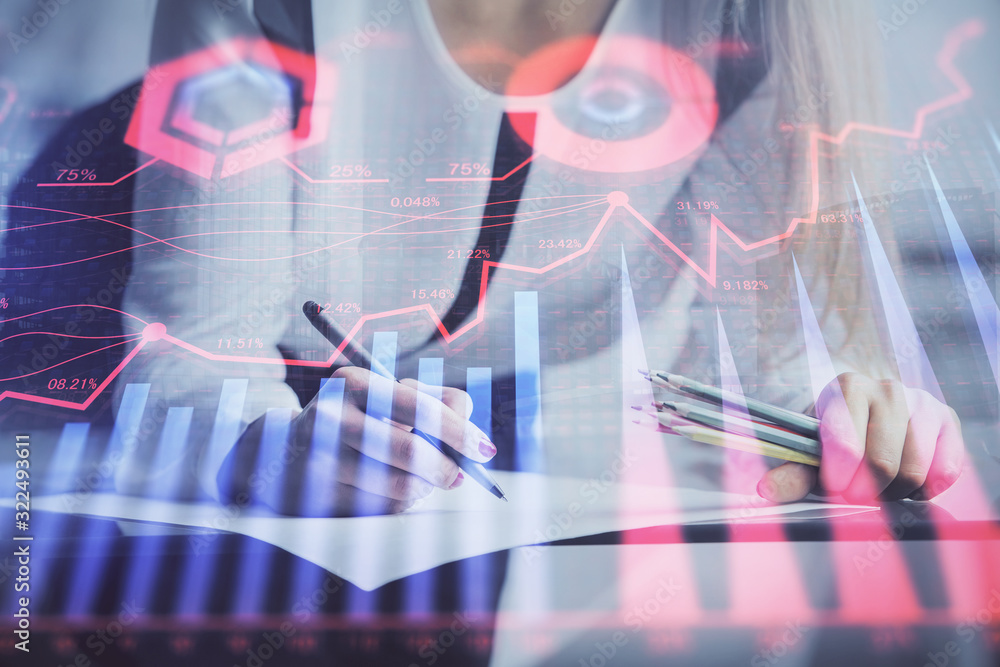 Double exposure of hands making notes with forex chart huds. Stock market concept. Double exposure of hands making notes with forex chart huds. Stock market concept.