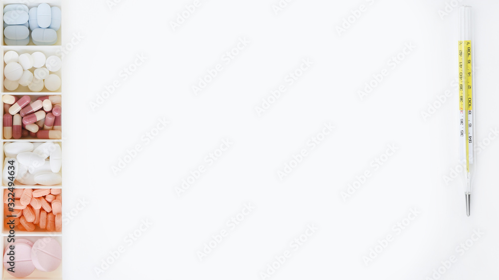 © thananya_k - close up of different medication with thermometers isolated on white background © thananya_k - close up of different medication with thermometers isolated on white background