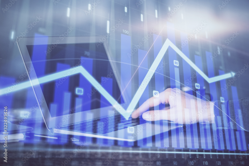 Double exposure of stock market graph with man working on laptop on background. Concept of financial analysis. Double exposure of stock market graph with man working on laptop on background. Concept of financial analysis.
