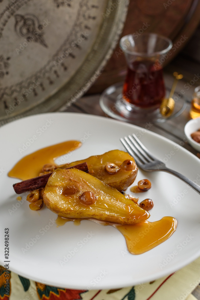 Cinnamon Poached Pears with Caramel Sauce and Hazelnuts