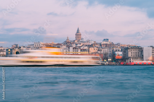Istanbul, Turkey - Jan 15, 2020: Galata Tower with Ferry Boat in Golden Horn , Istanbul, Turkey,
