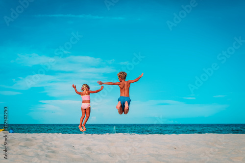 happy boy and girl enjoy beach, kids play on sea vacation