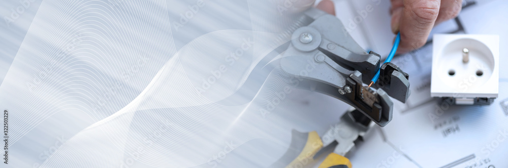 Electrician stripping a wire; panoramic banner Electrician stripping a wire; panoramic banner