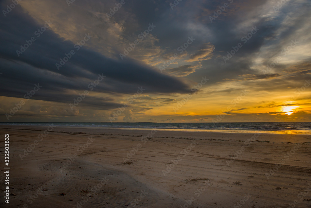 Beach and dramatic sunset. Gunn Point beach, Darwin, Australia, 03/17/19.